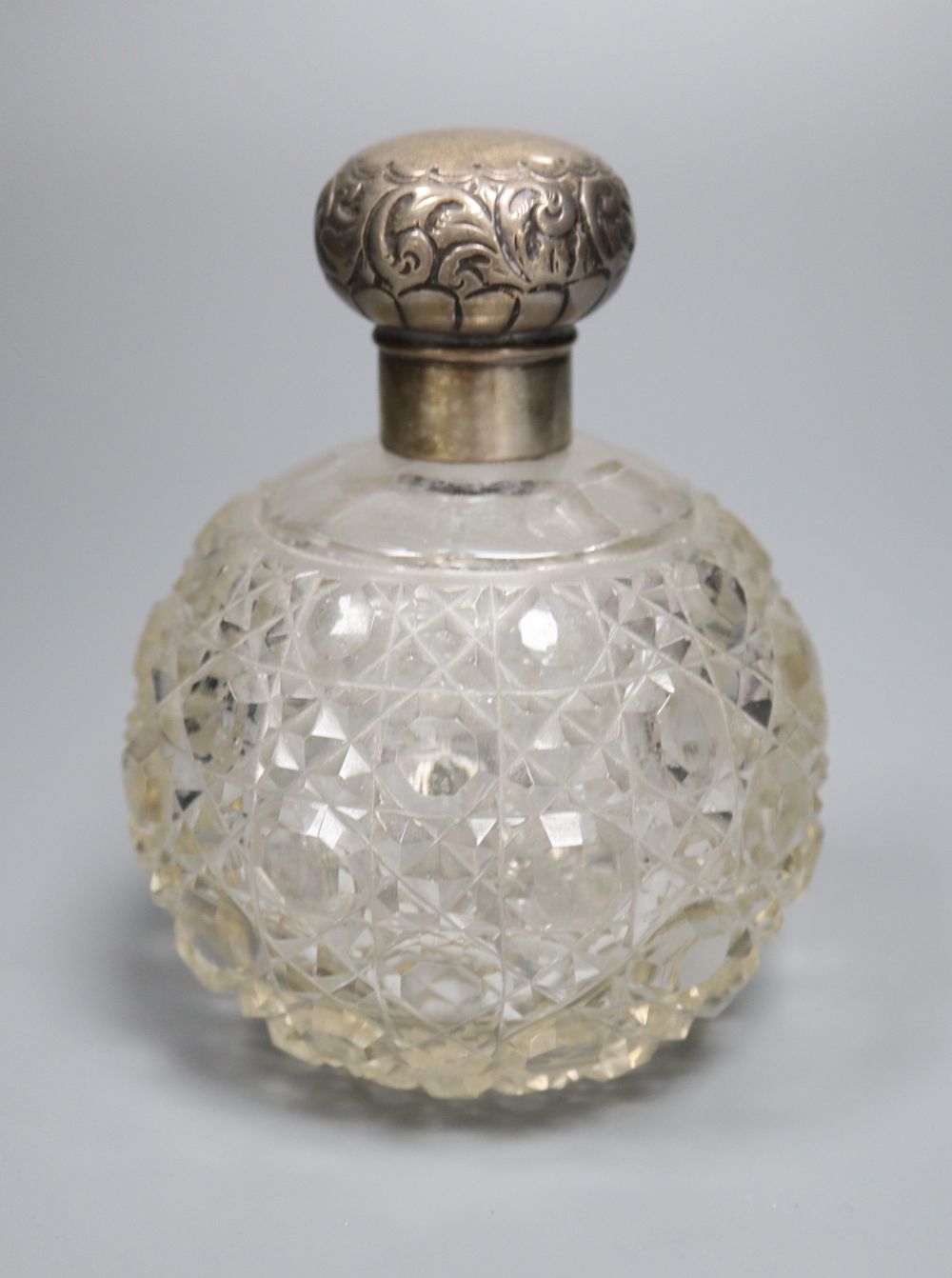 An Edwardian silver topped spherical hobnail cut glass scent bottle, Birmingham, 1907, height 12.5cm.